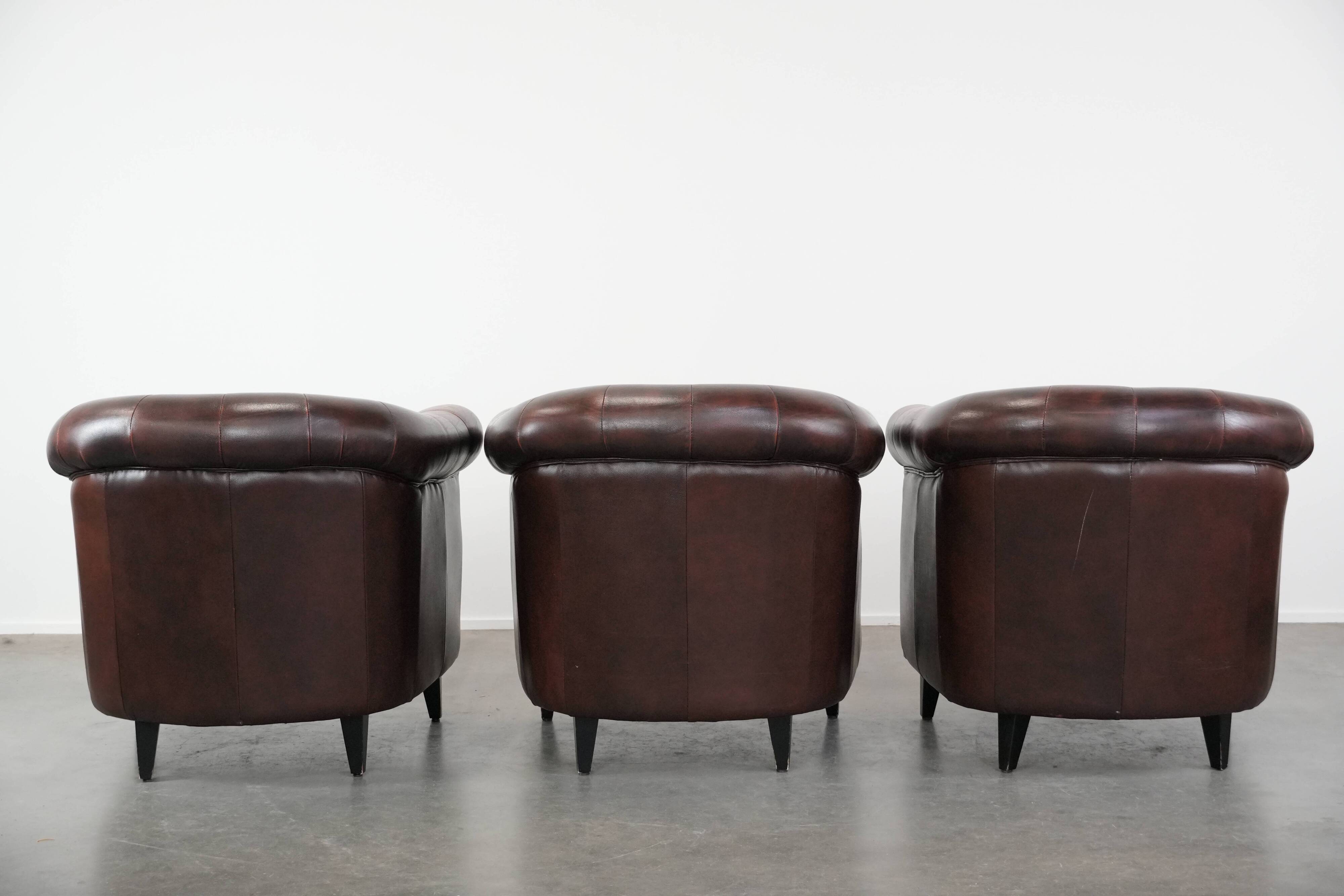 Set of three classic English-style Chesterfield cowhide  club armchairs