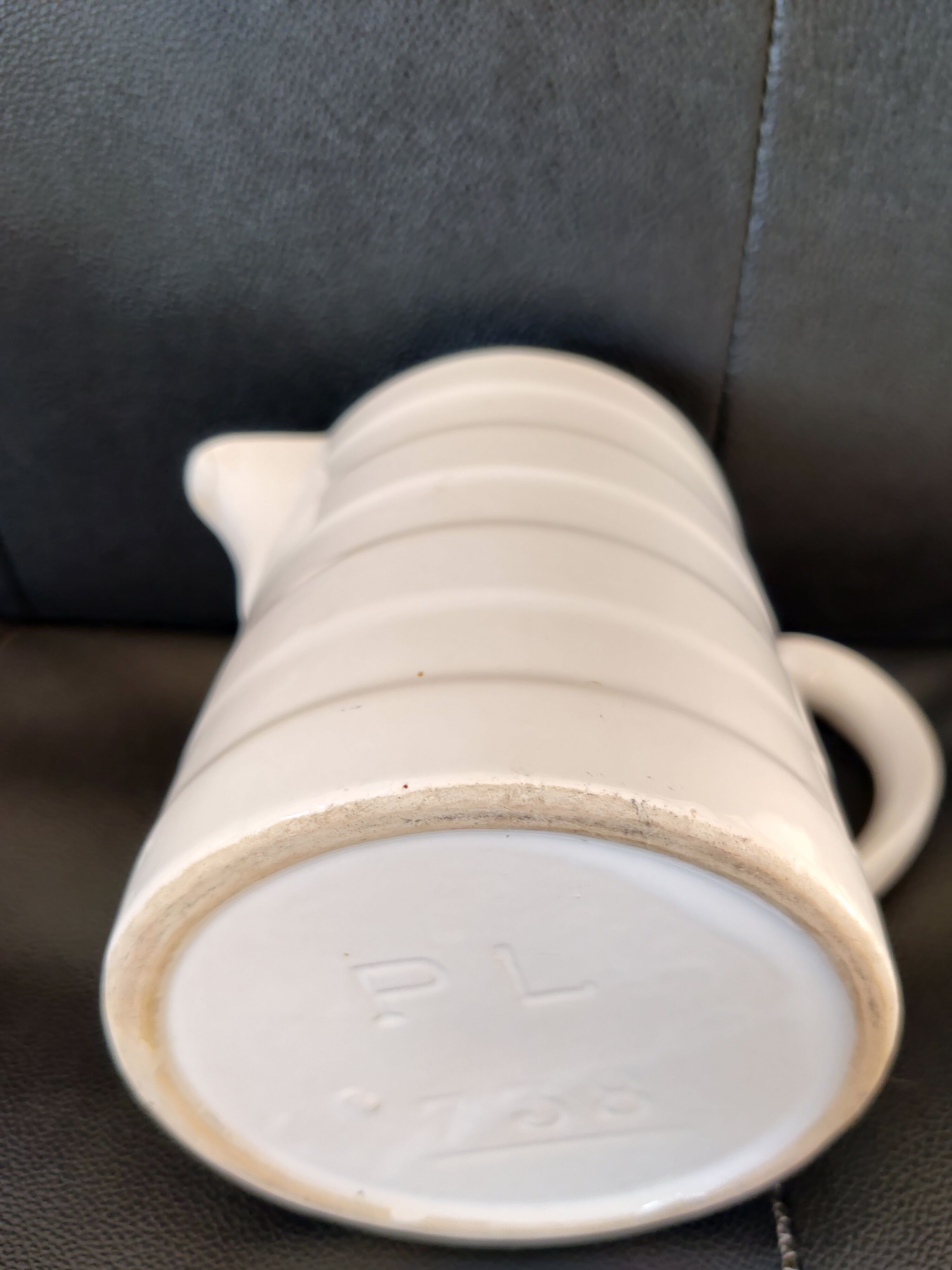 Antique white ceramic pitcher