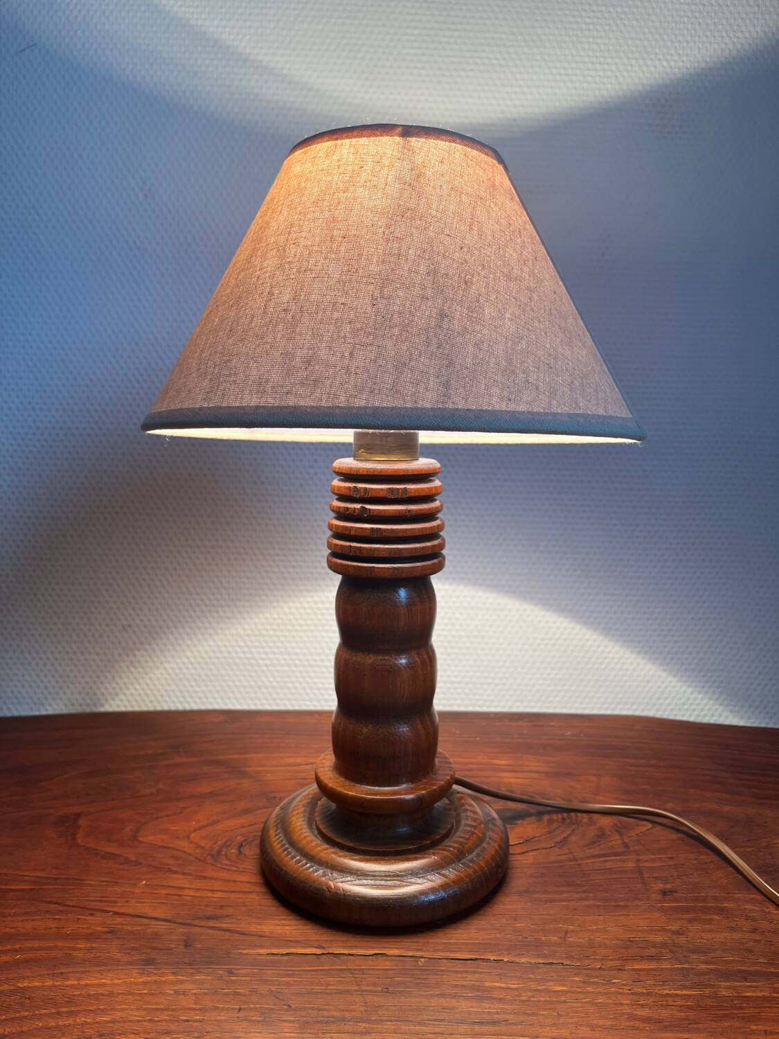 Table lamp with carved wooden base