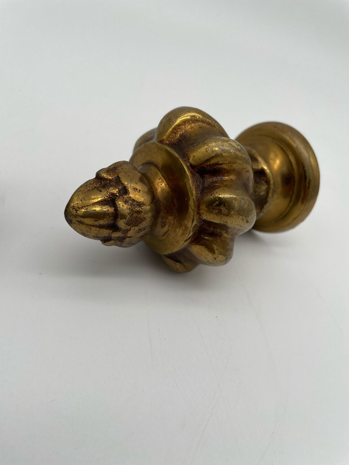 Pair of antique flame curtain rod finials in gilded bronze