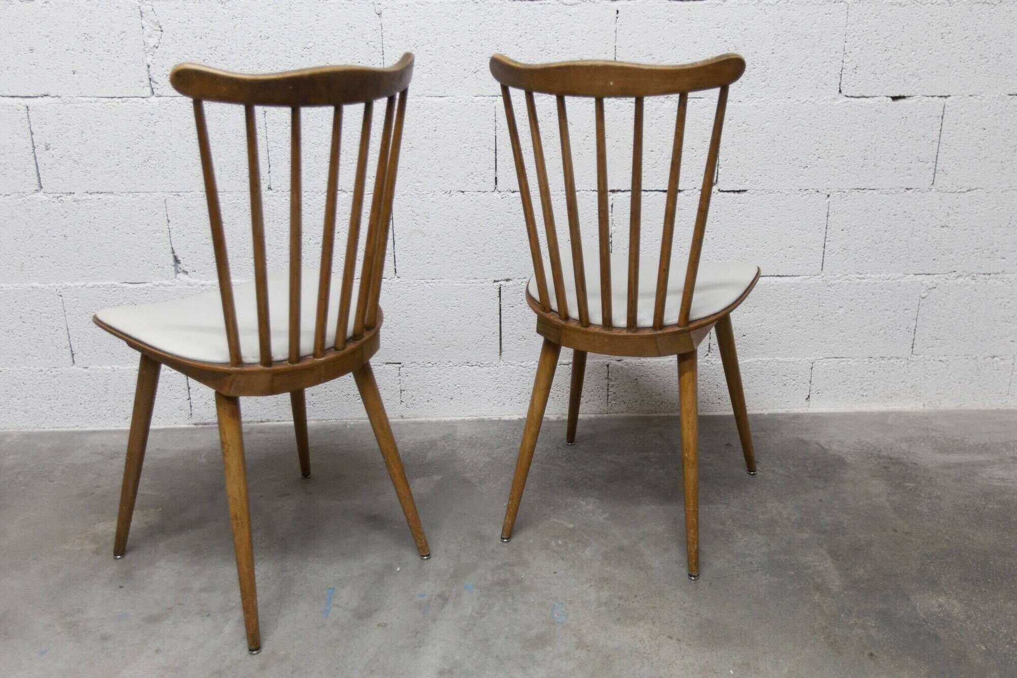 Pair of Baumann Menuet chairs, Honey patina, White skai seat