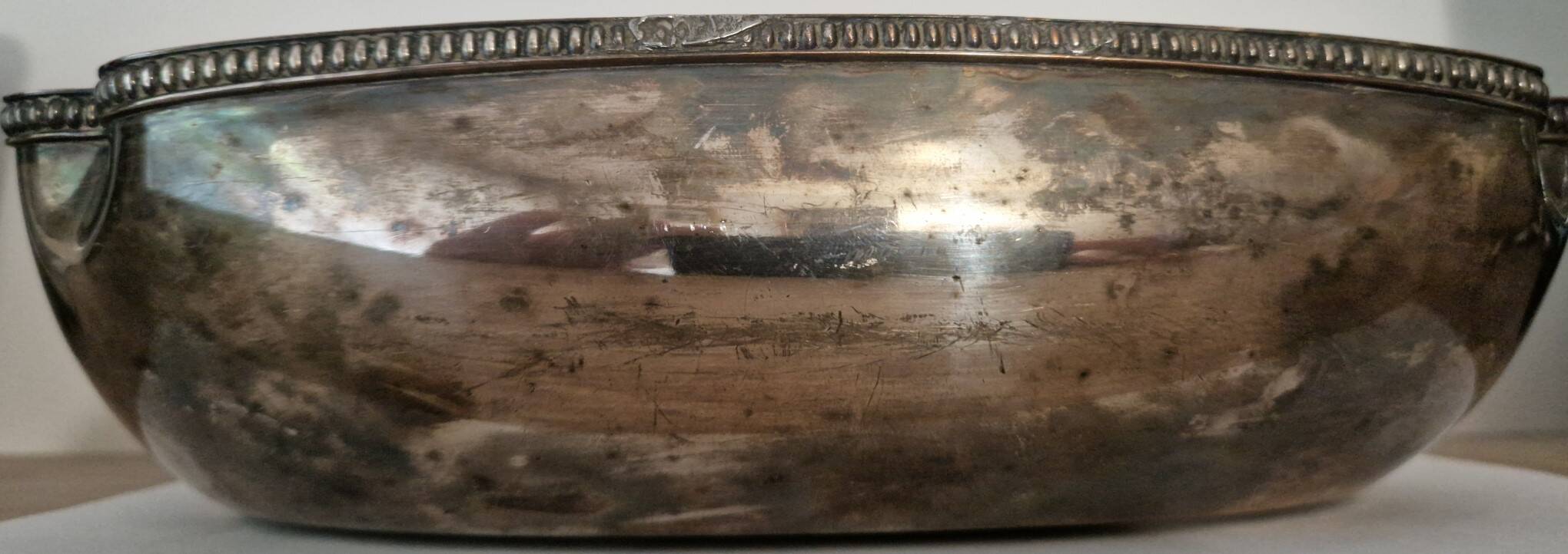 I037 Large shallow antique silver-plated dish in the Louis XVI style with bead decoration.