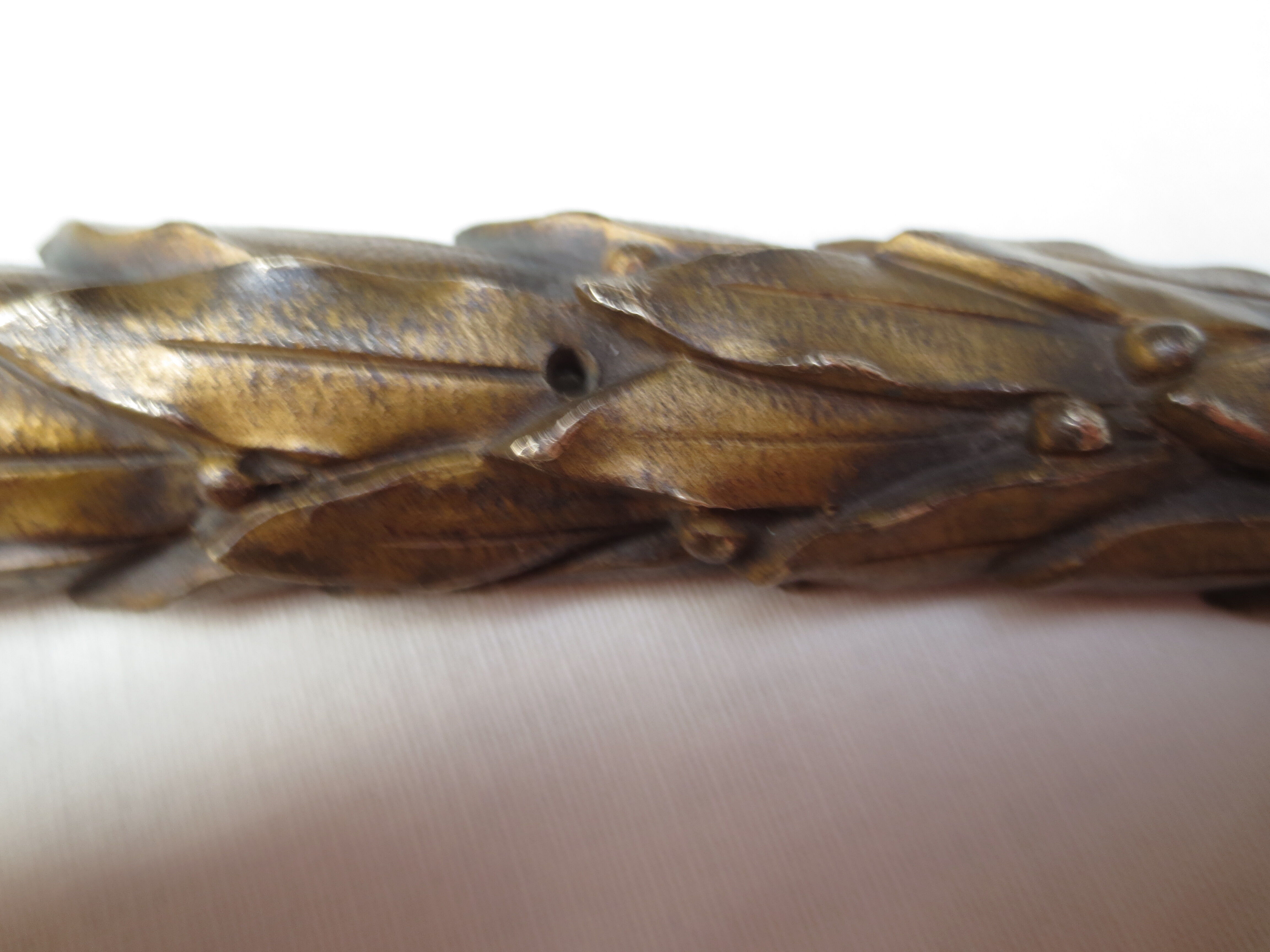 old bronze curved pediment