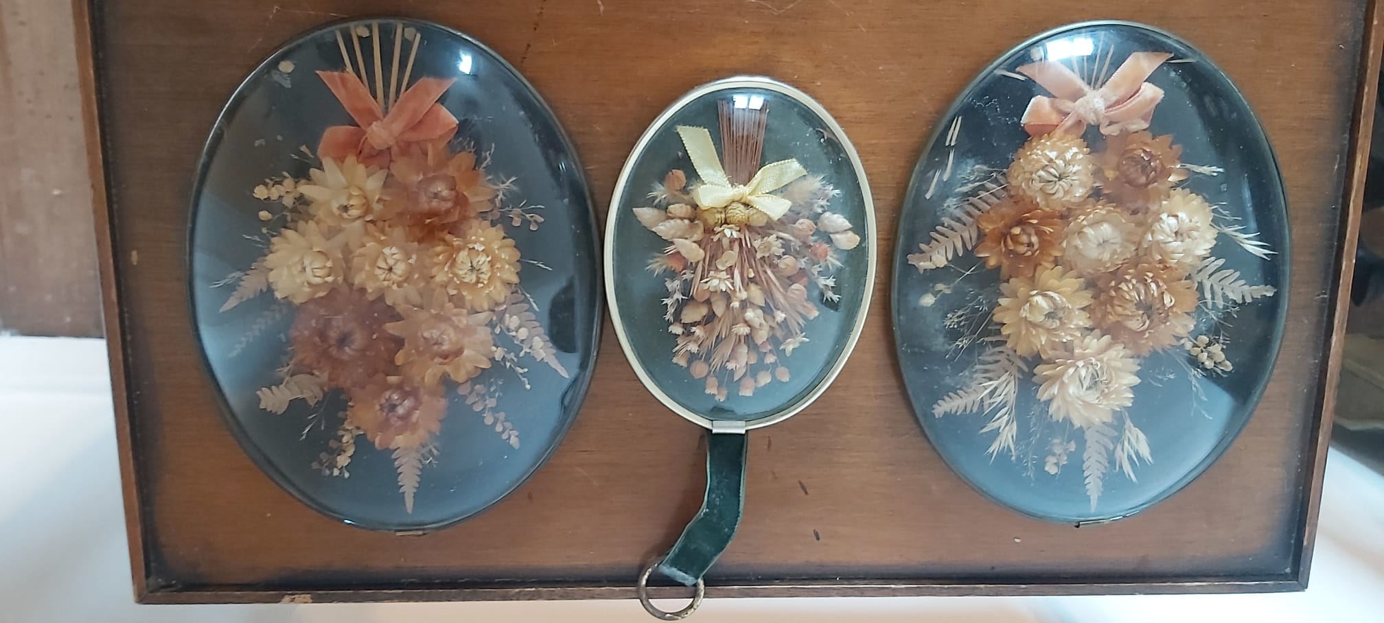 3 frames of dried flowers in curved glass
