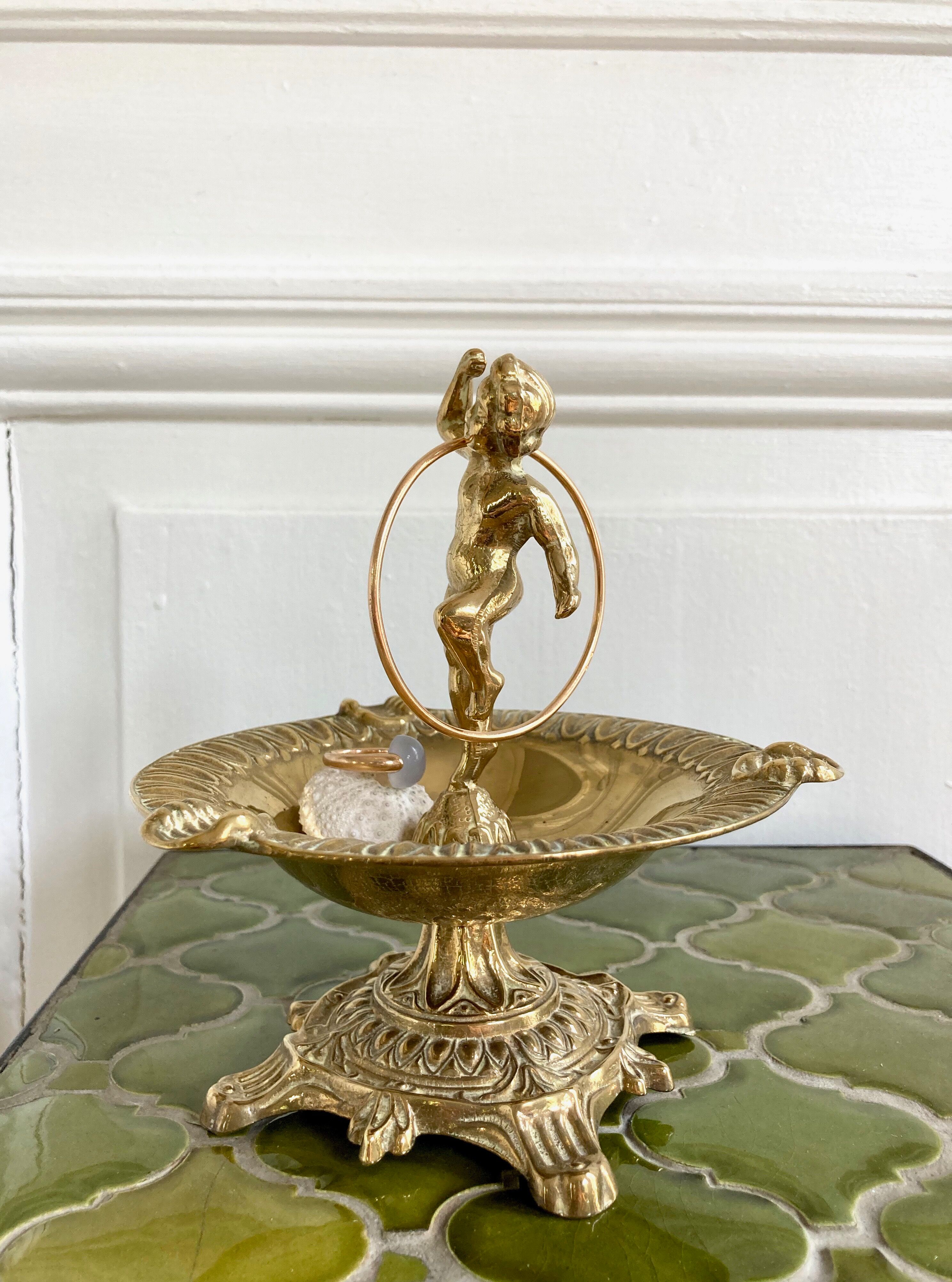 Brass cherub pocket-empty ashtray