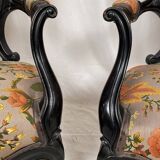 Pair of Napoleon III armchairs, in blackened wood, floral patterned fabric