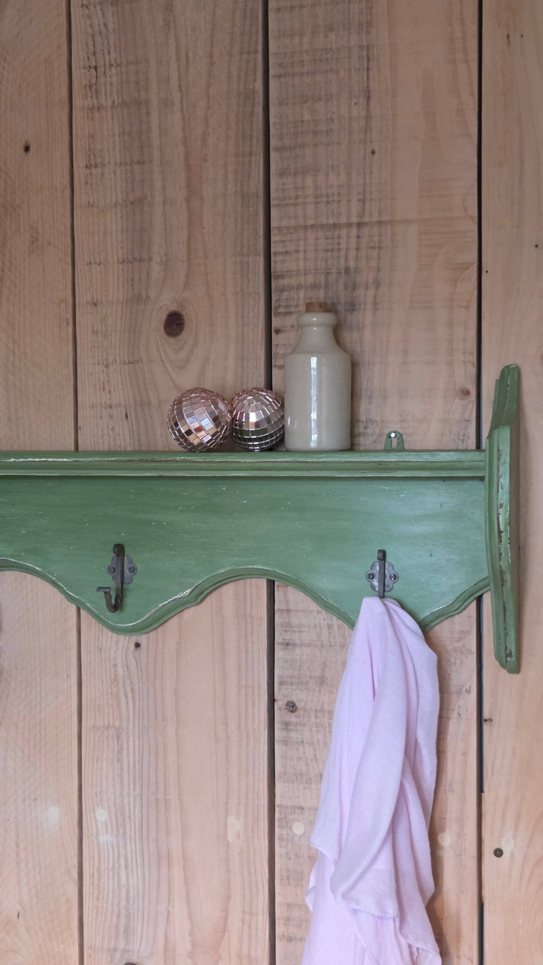 Antique wall shelf with a green patina