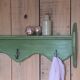 Antique wall shelf with a green patina