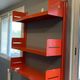Modular red metal wall shelf in Congresso Lips Vago style.