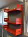 Modular red metal wall shelf in Congresso Lips Vago style.