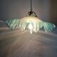 Suspension lampshade with scalloped edges in blue and its interior decoration.