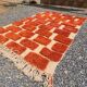 Large Moroccan Berber rug in orange and ecru wool, 400 x 300 cm.