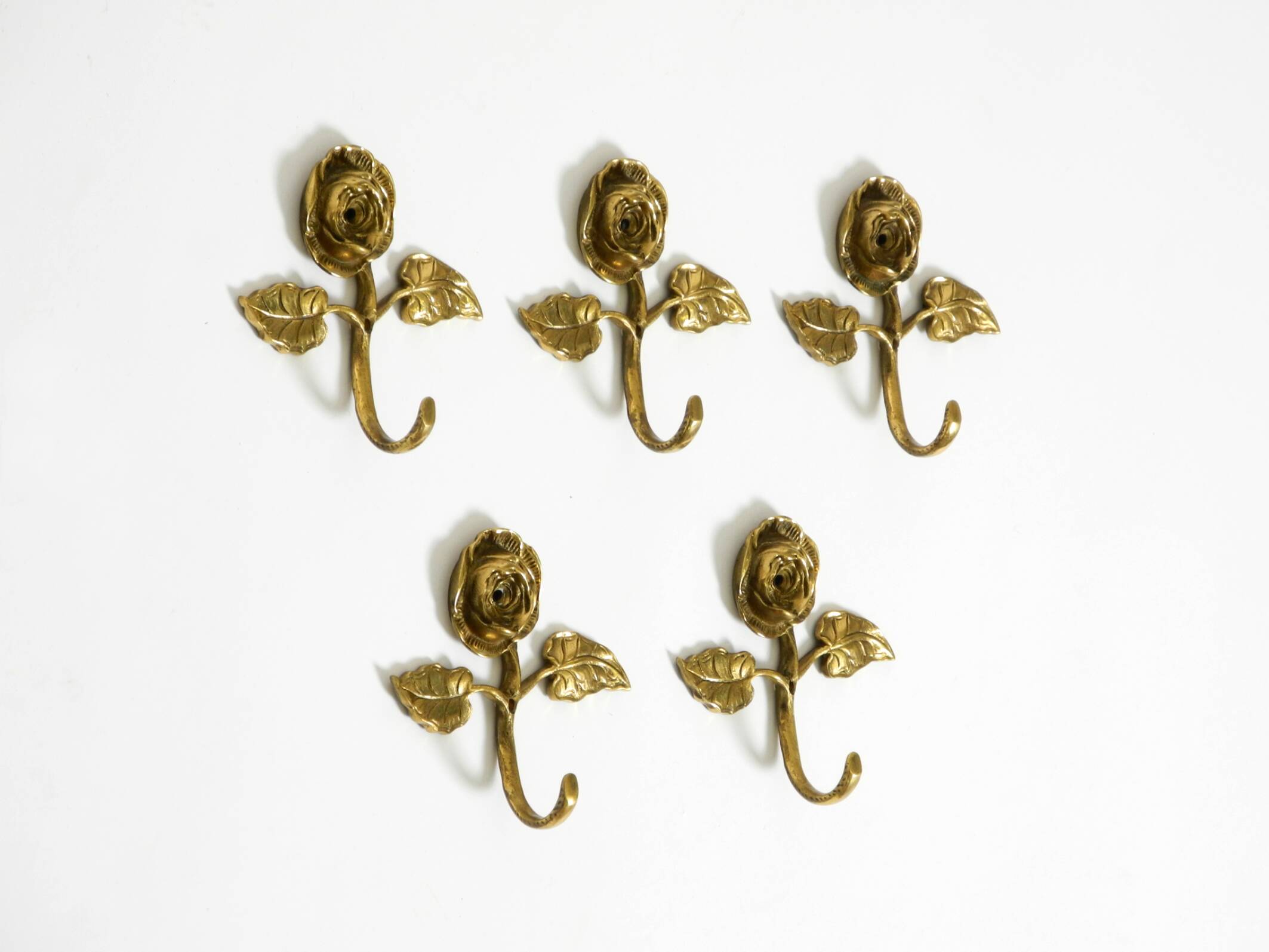 Set of five beautiful, solid mid-century brass rose wall coat hooks