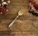 Engraved meat fork in silver and gold metal