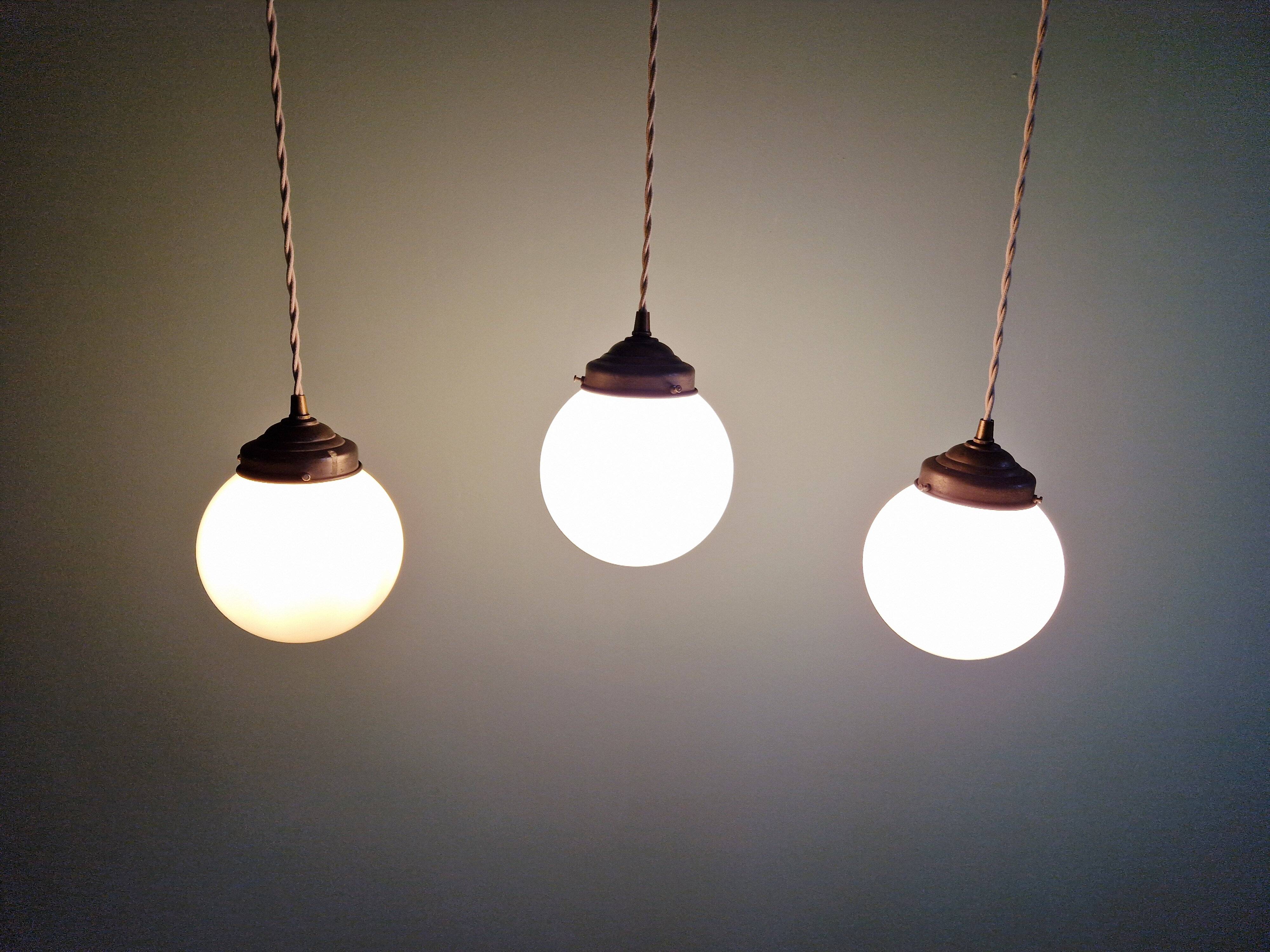 Art Deco trio of suspensions in white opaline, 1930s