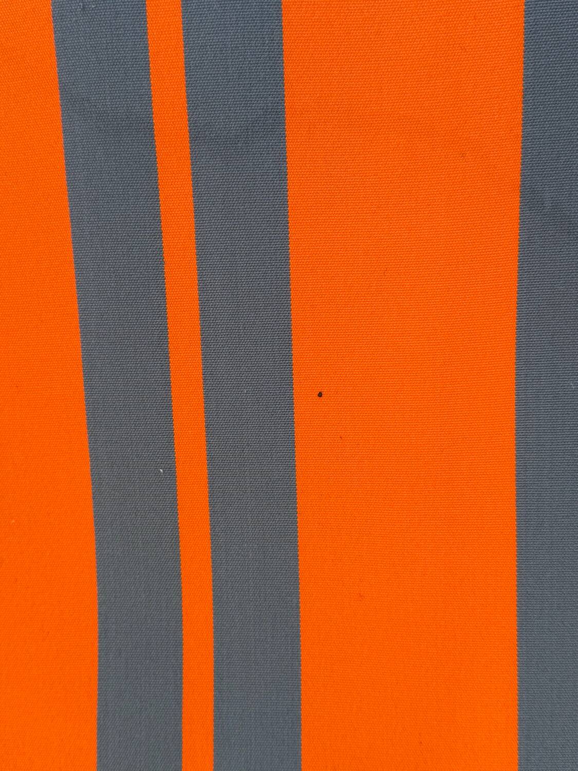 Vintage deck chair with orange and grey striped fabric, original patina.