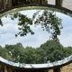 Bevelled oval mirror, richly crafted Art Deco wrought iron.