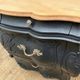 Curved commode painted in black and wood.