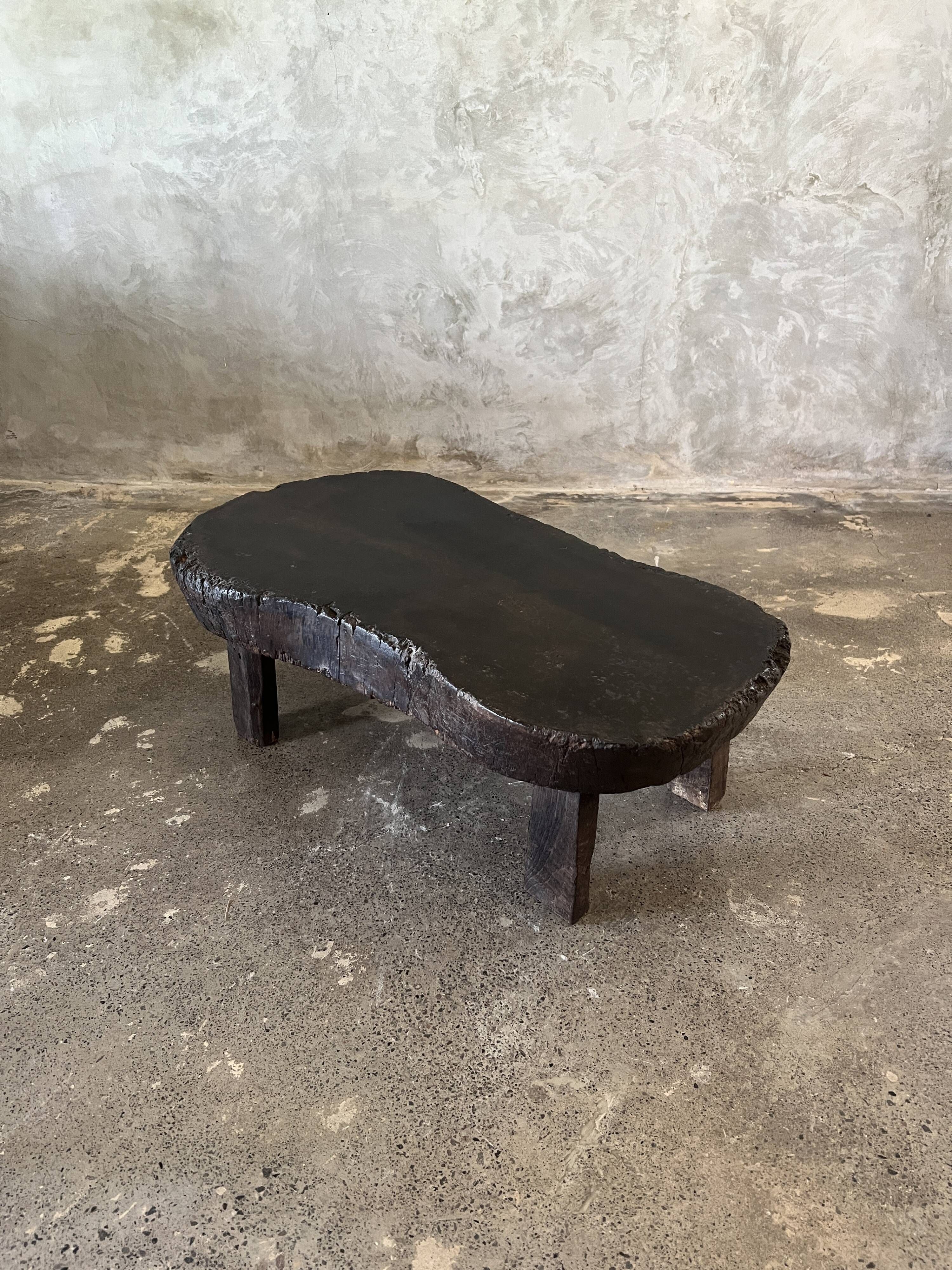 Small old Asian wooden coffee table in Japanese style, kidney-shaped top