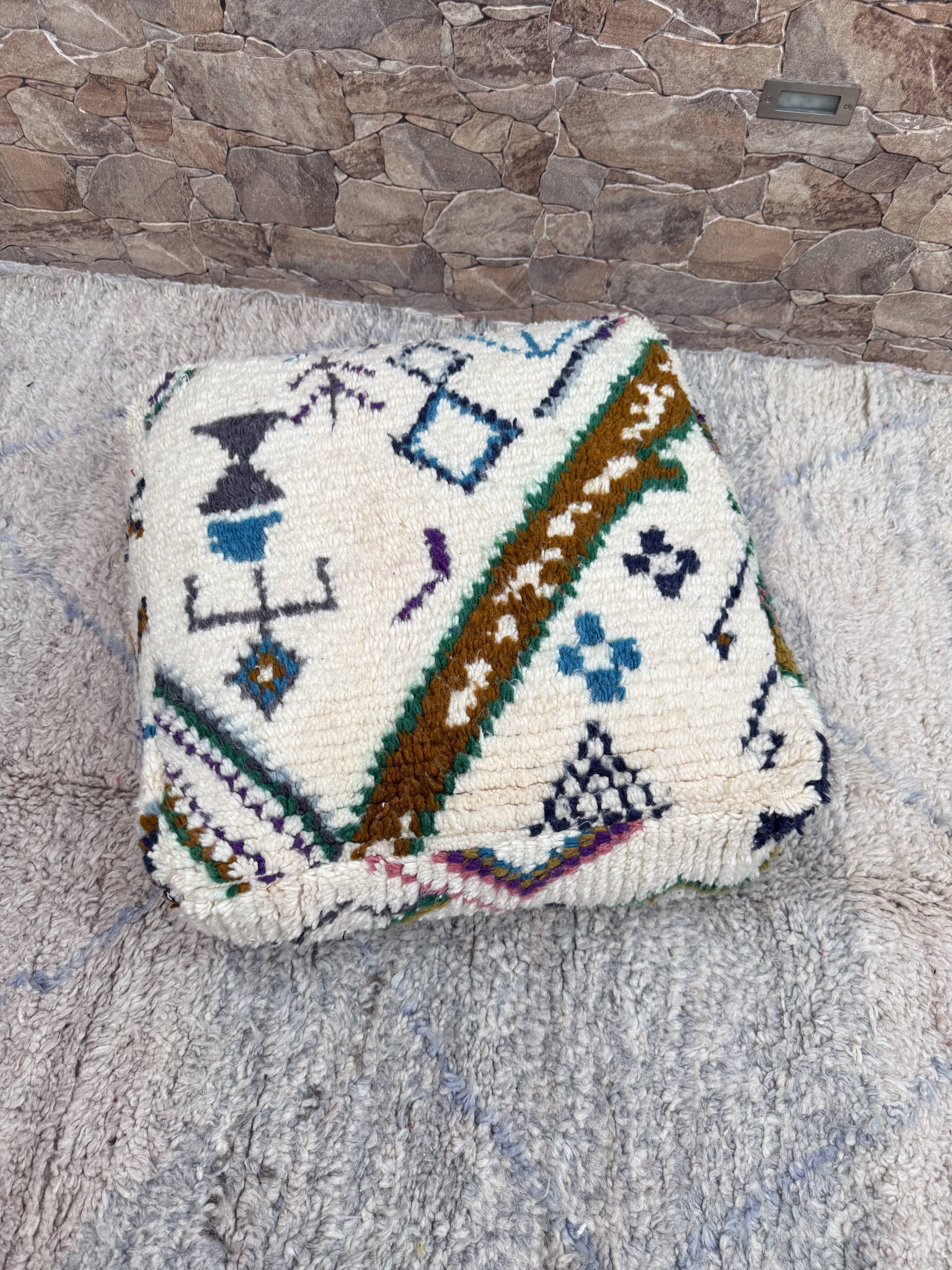 Berber floor pouf: Handwoven Moroccan wool cushion.