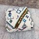 Berber floor pouf: Handwoven Moroccan wool cushion.