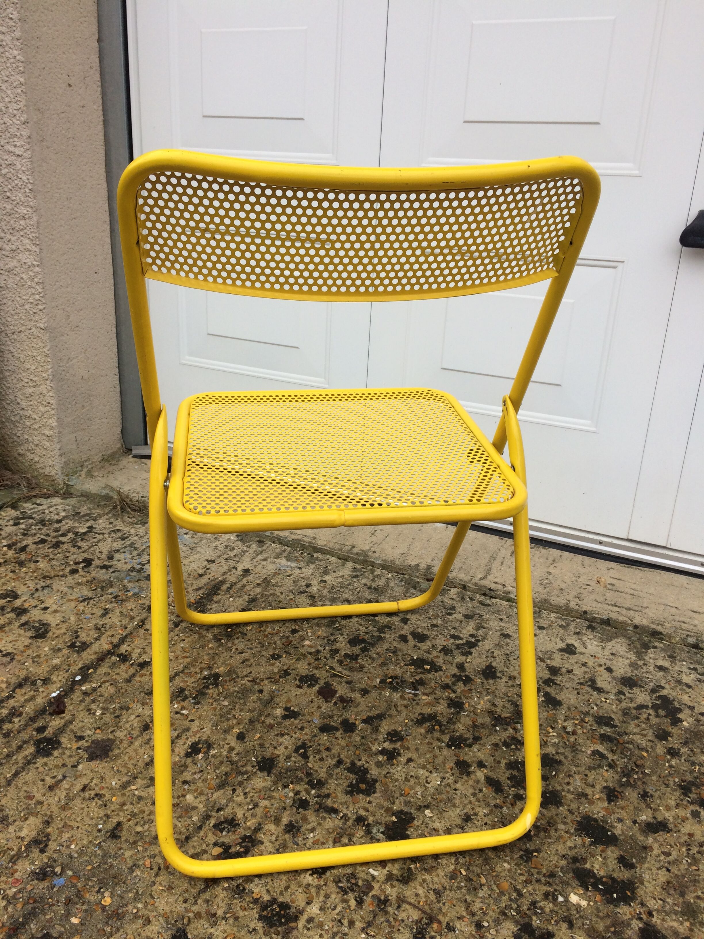 Perforated folding metal chair