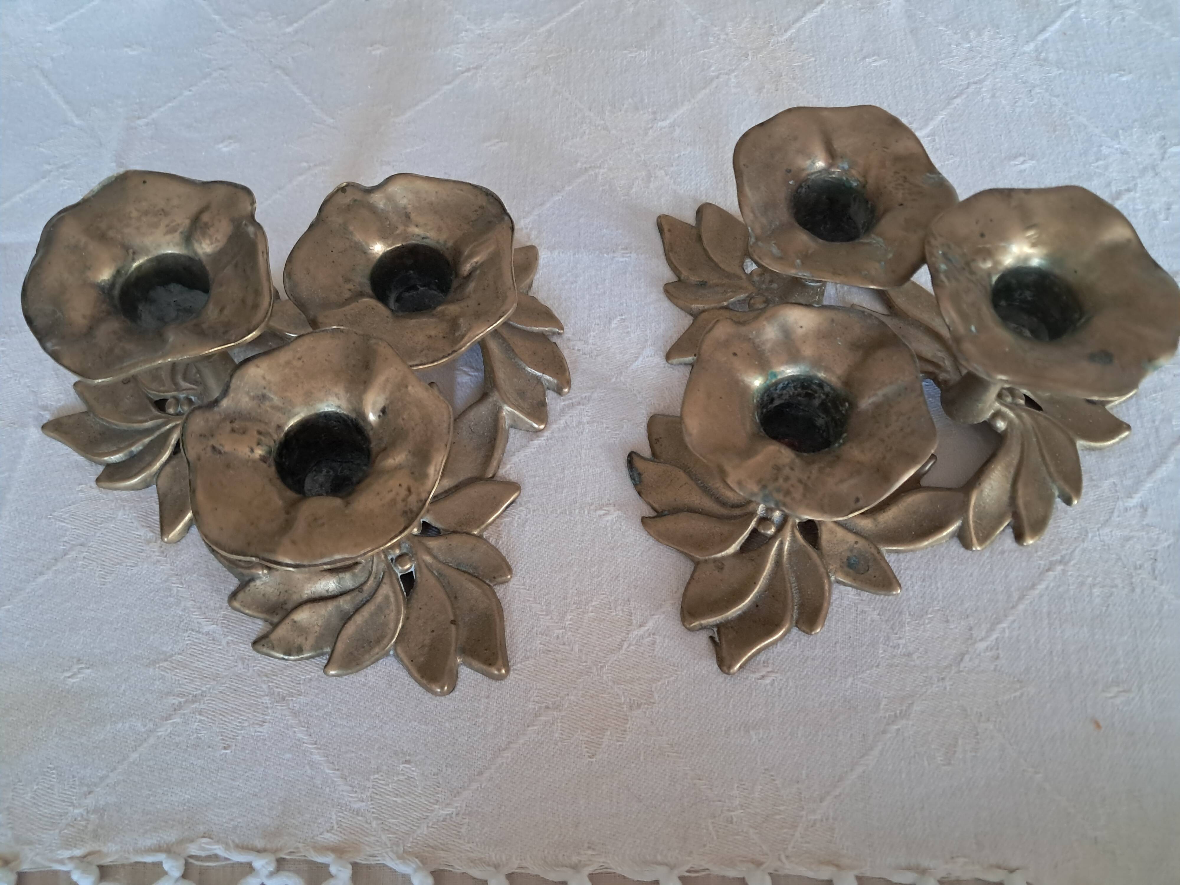 Pair of antique three-branch candlesticks with a floral design.