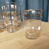 Set of 9 old glasses with golden net