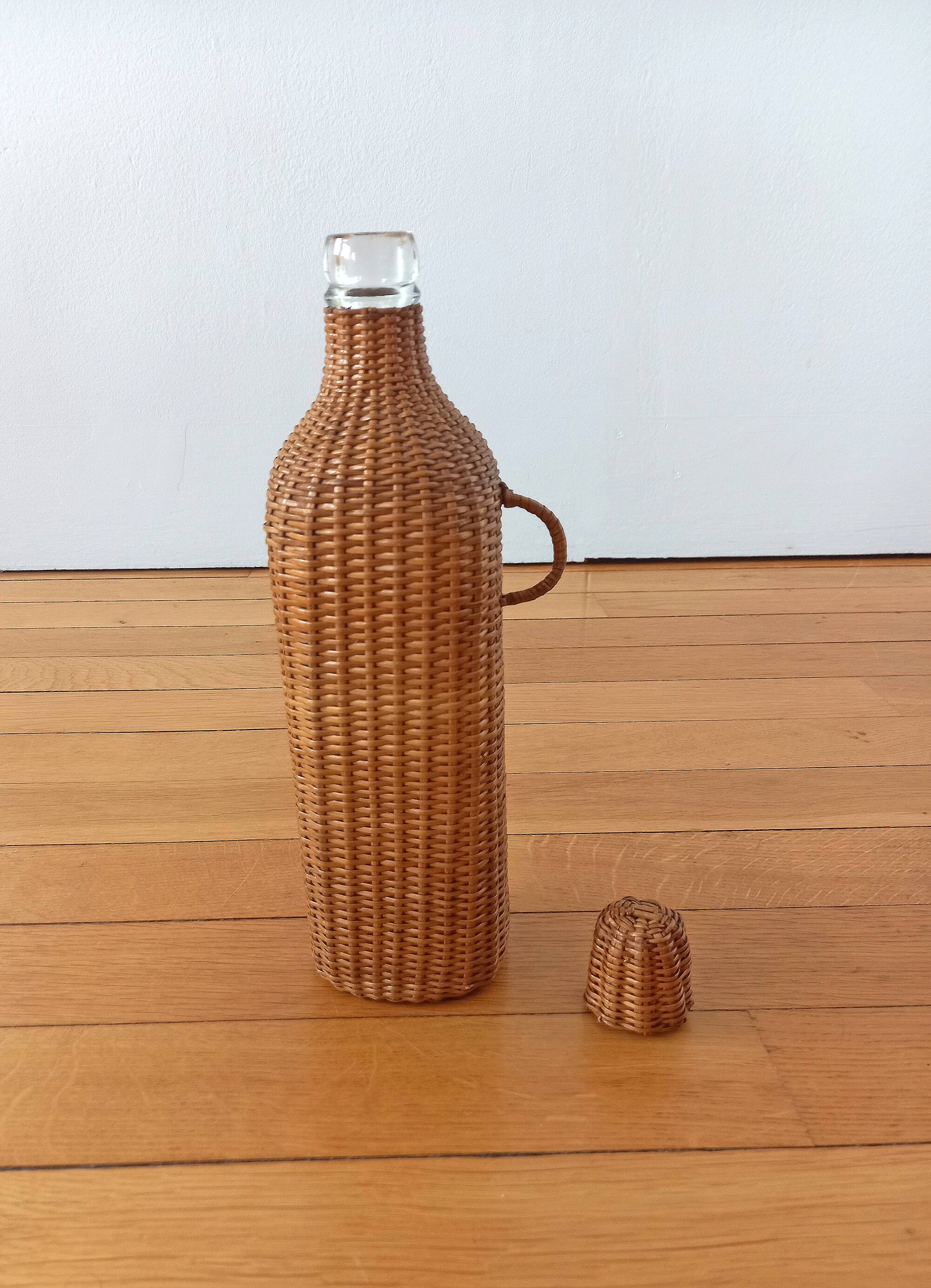 Bottle, old carafe in glass and wicker, 1950s