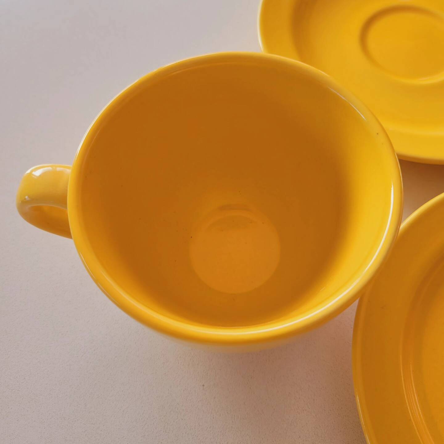 4 yellow cups and saucers