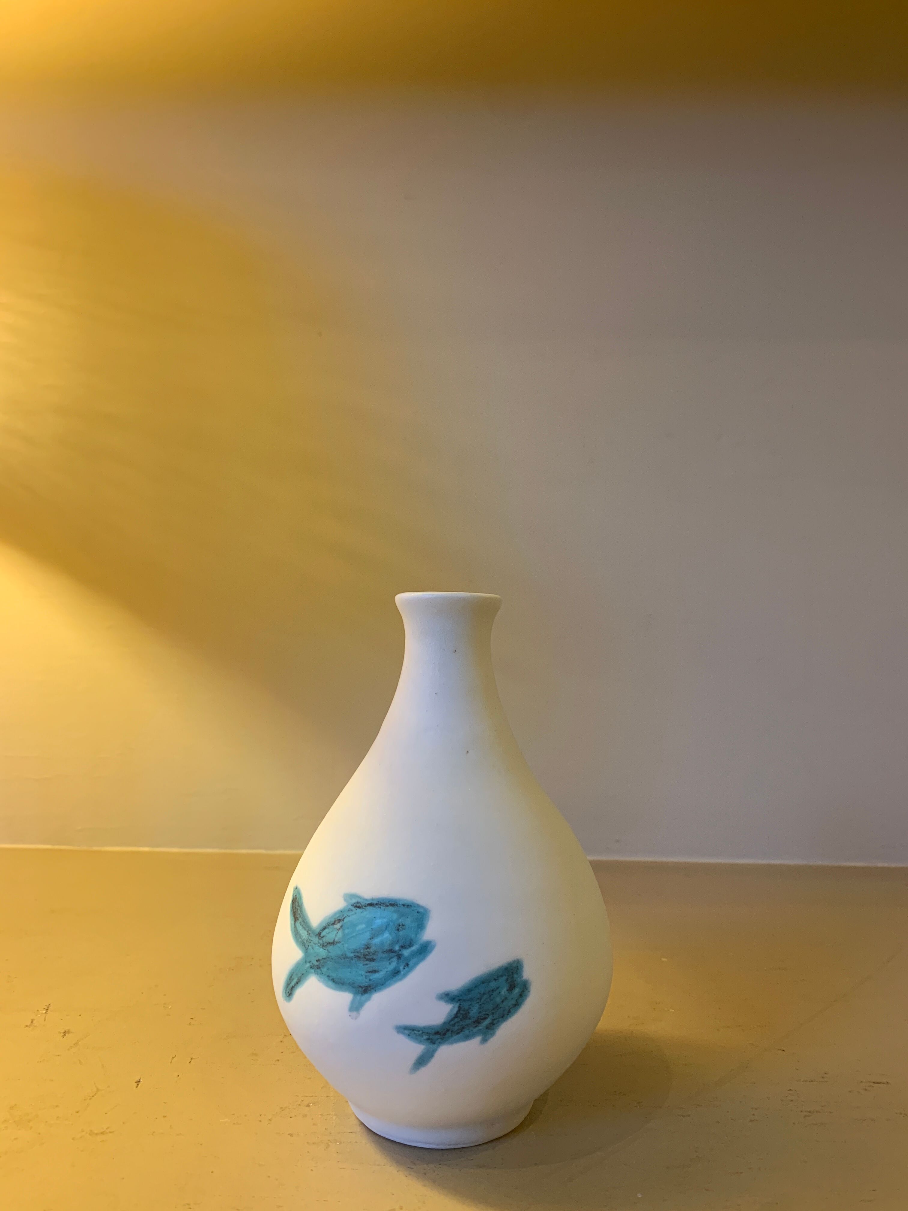 White ceramic with dolphin motif