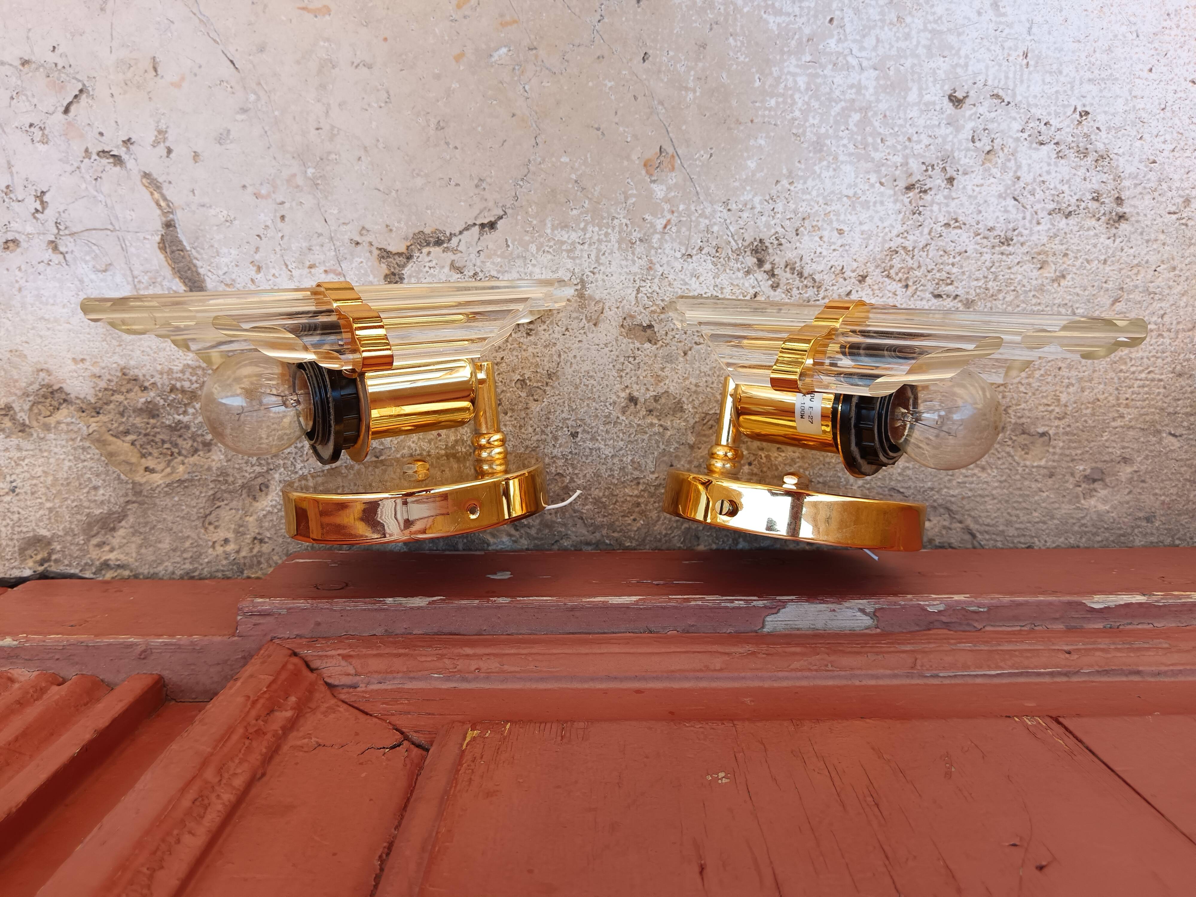 Pair of wall sconces in crystal glass and gilded brass. Venini style.