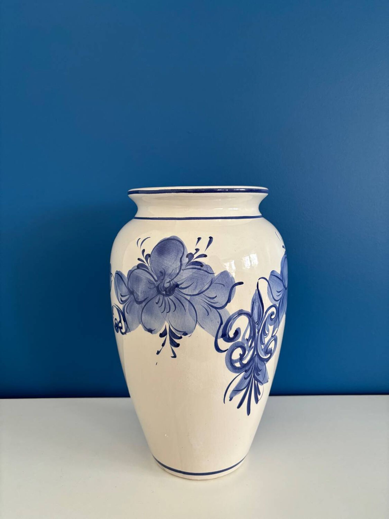 Vintage white and blue ceramic vase with floral pattern