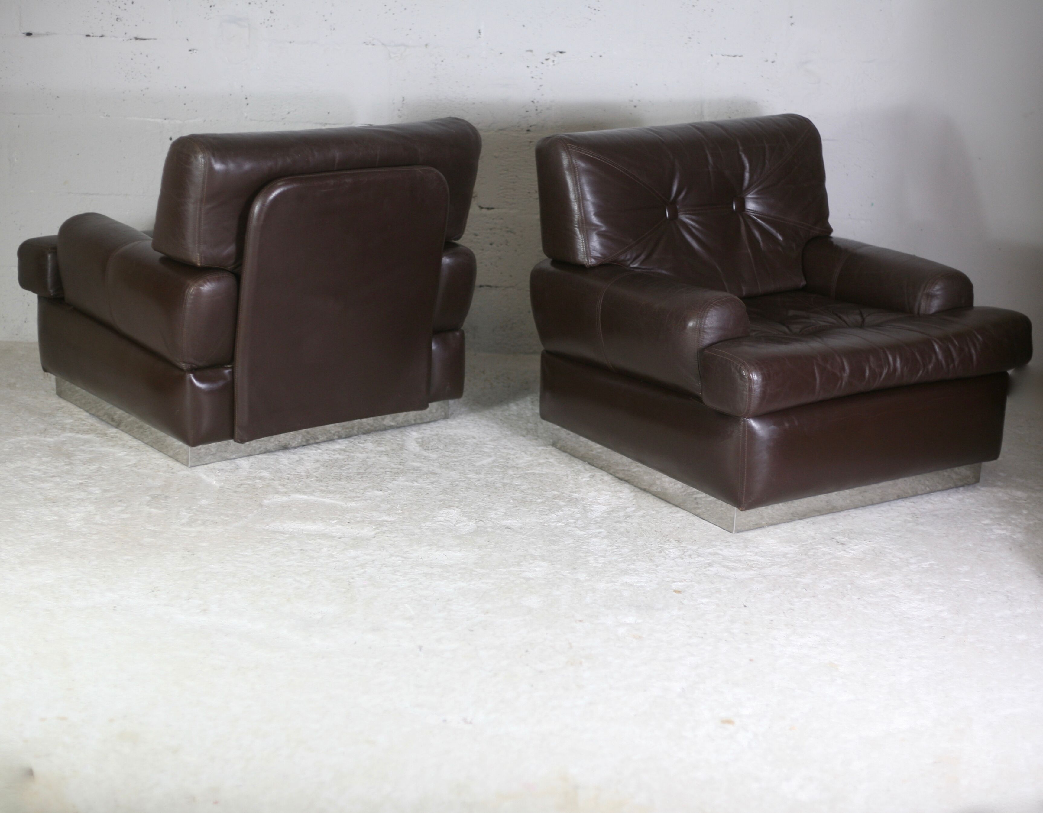 Pair of armchairs brown leather base stainless steel, France, circa 1970