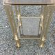Pair of Hollywood Regency side tables in gold metal and smoked glass.