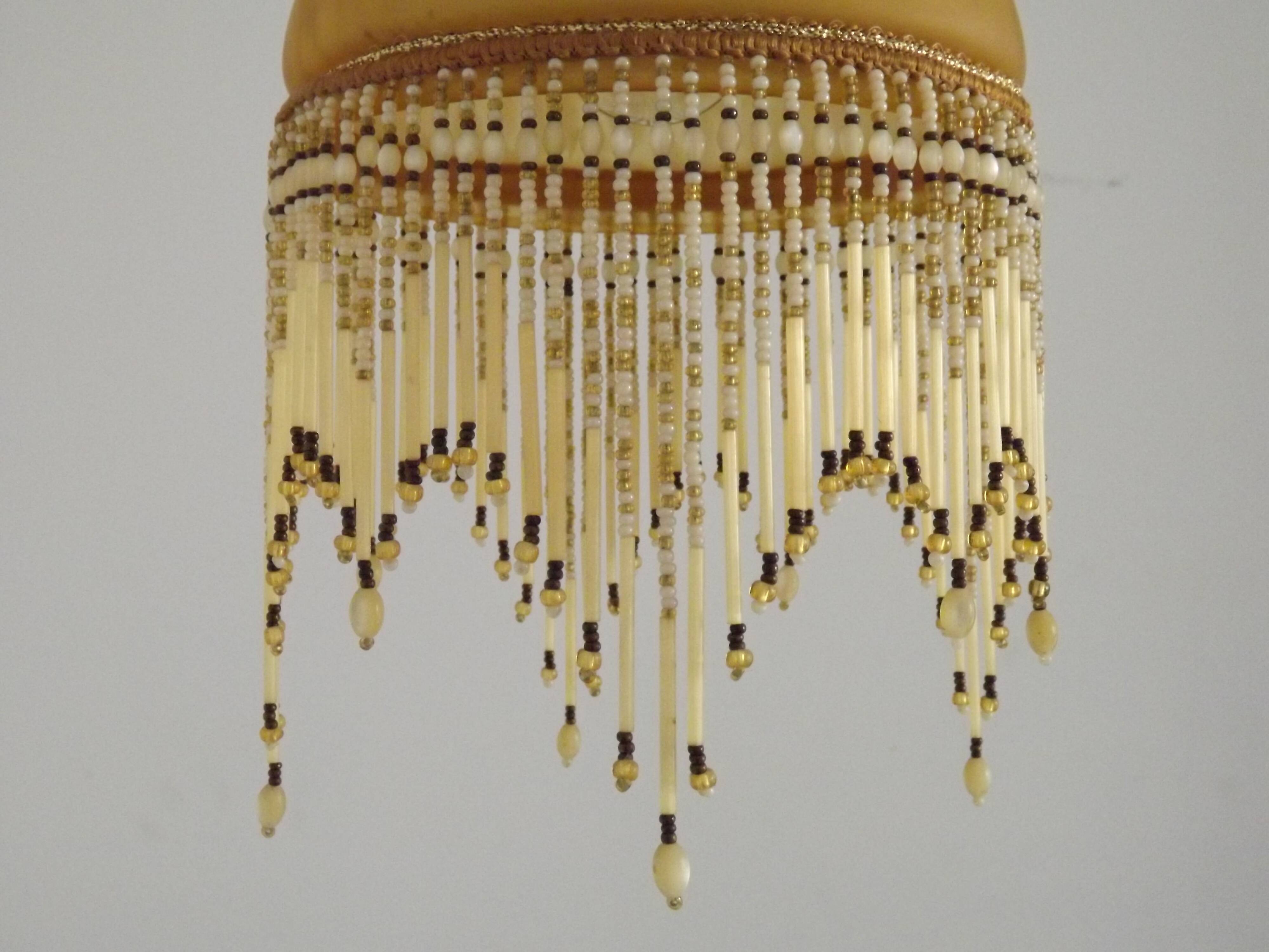 Vintage French amber mottled glass hanging ceiling light with beaded fringe.