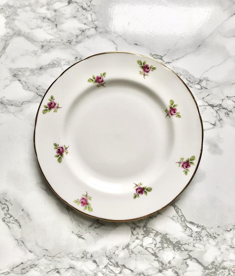 Teacup on its saucer and porcelain cake plate