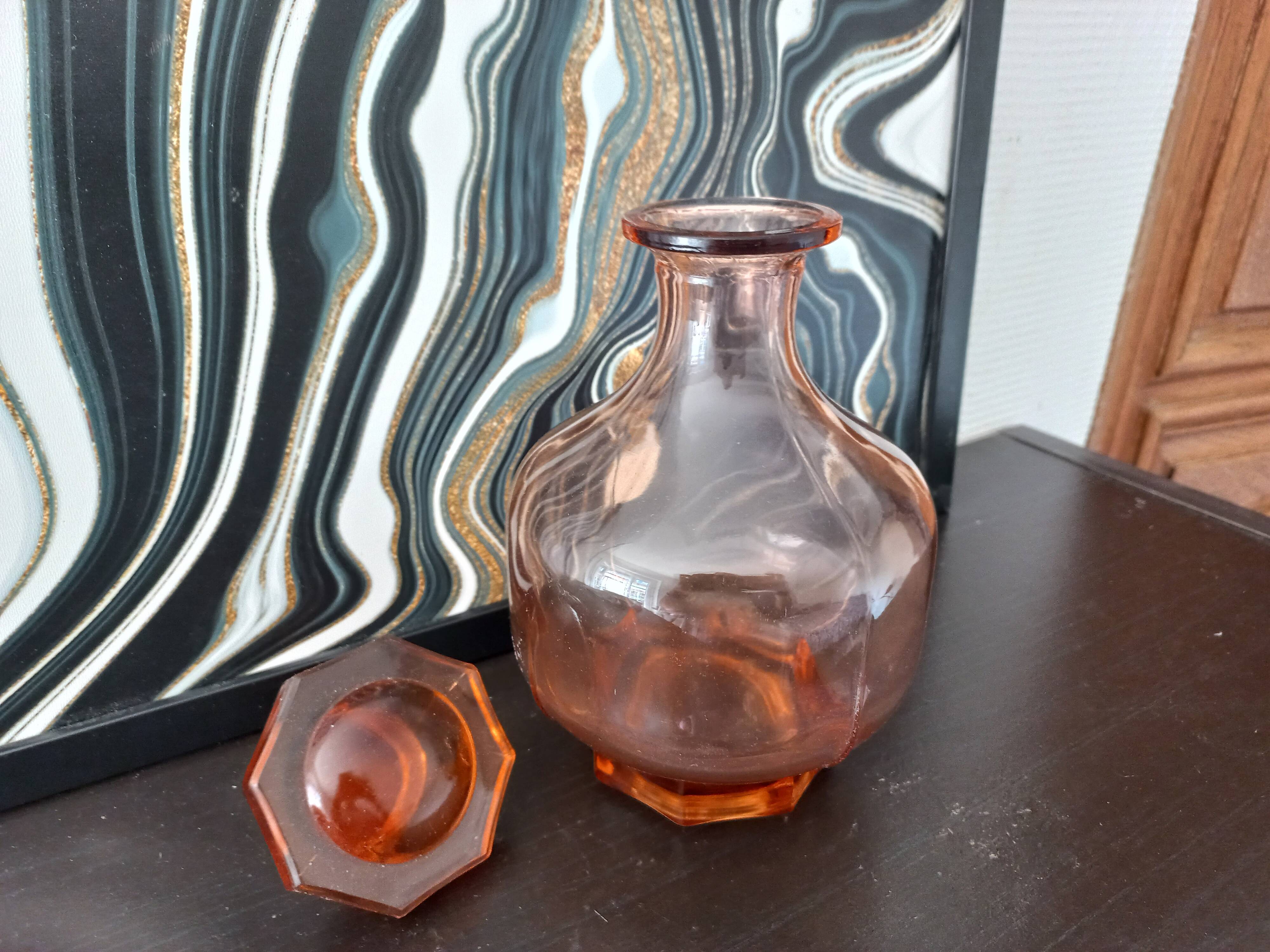 Vintage glass carafe in pink-orange, retro-chic style.