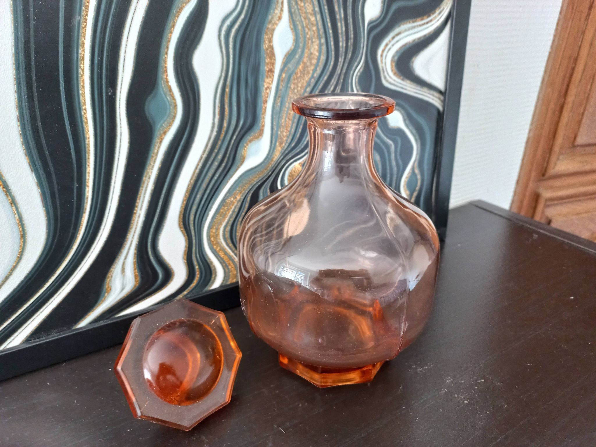 Vintage glass carafe in pink-orange, retro-chic style.