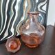 Vintage glass carafe in pink-orange, retro-chic style.