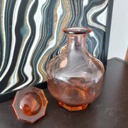 Vintage glass carafe in pink-orange, retro-chic style.