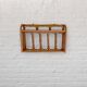 Pale pink rattan wall shelf