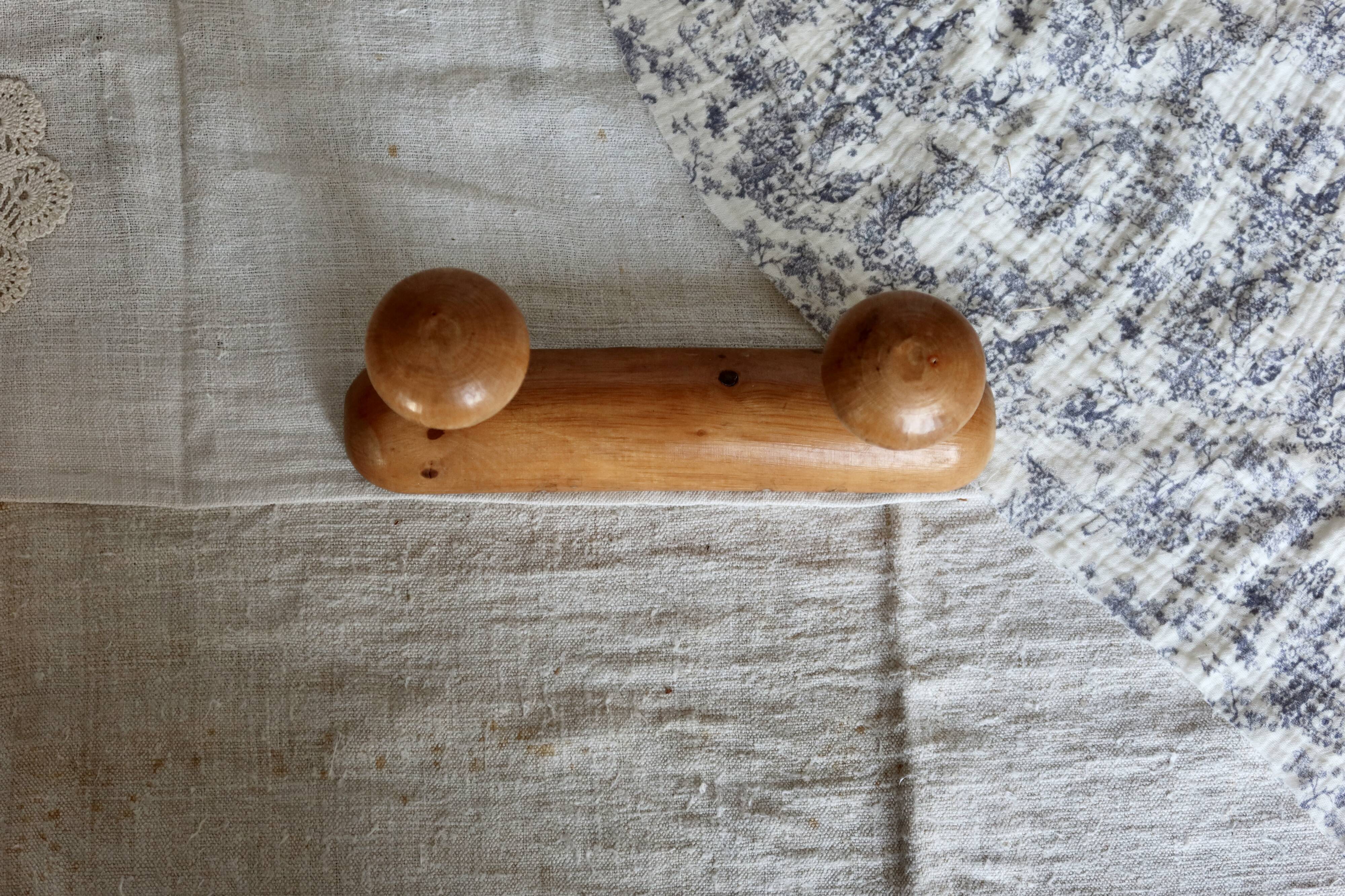 Antique wooden coat rack with two round hooks