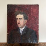 Old oil painting on cardboard portrait of a man in a dark suit