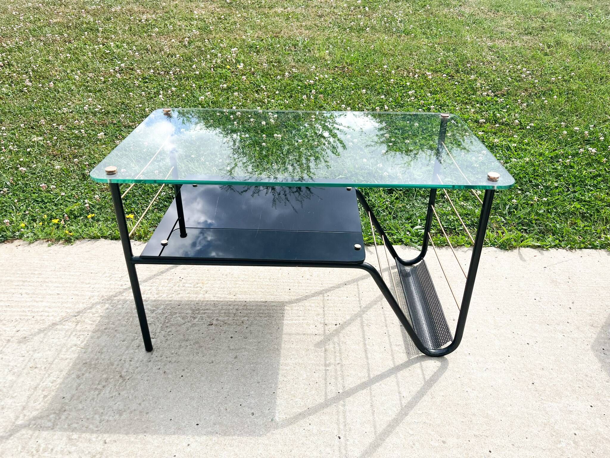 Metal and glass coffee table with magazine rack by Roche Bobois from the 1950s.