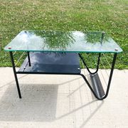 Metal and glass coffee table with magazine rack by Roche Bobois from the 1950s.