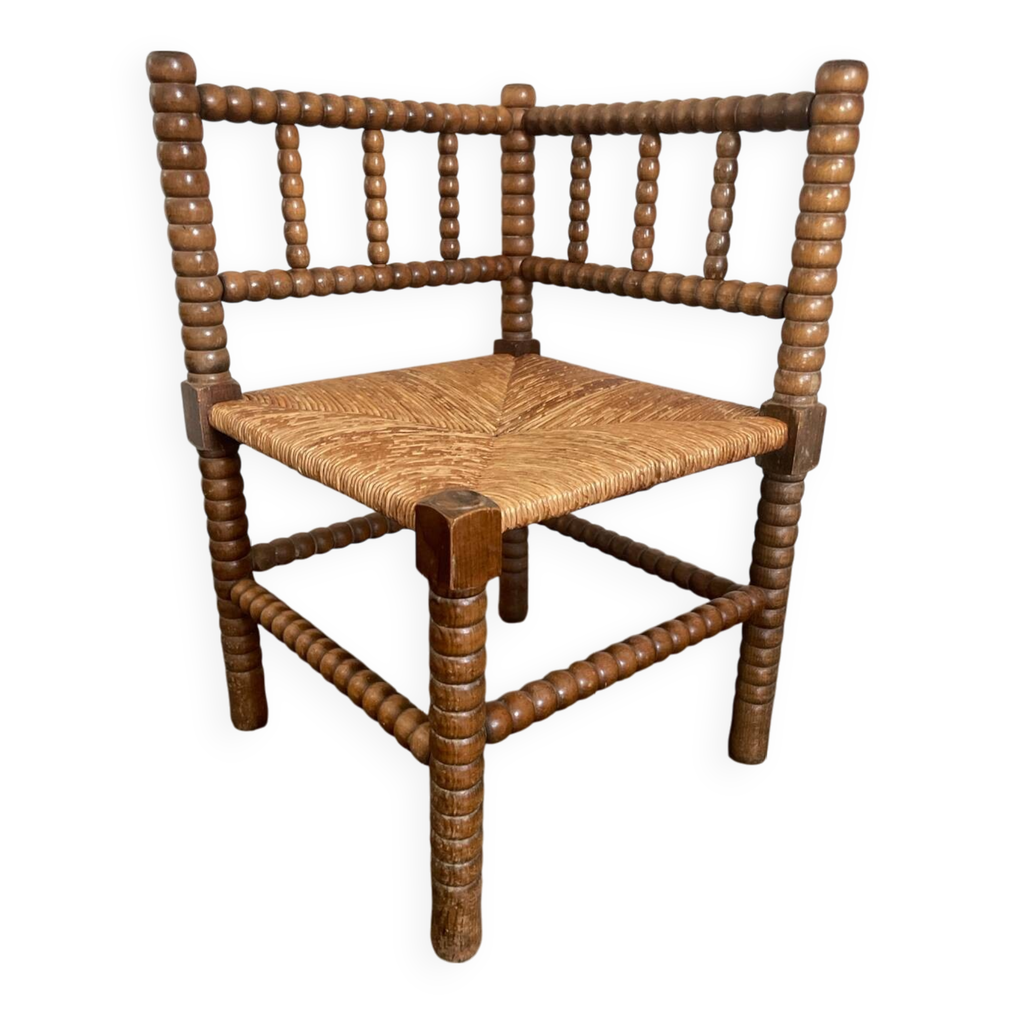 Old armchair, corner chair, made of wood and straw
