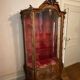 Large wooden display cabinet in Louis XV/rococo style with a strongly curved front.
