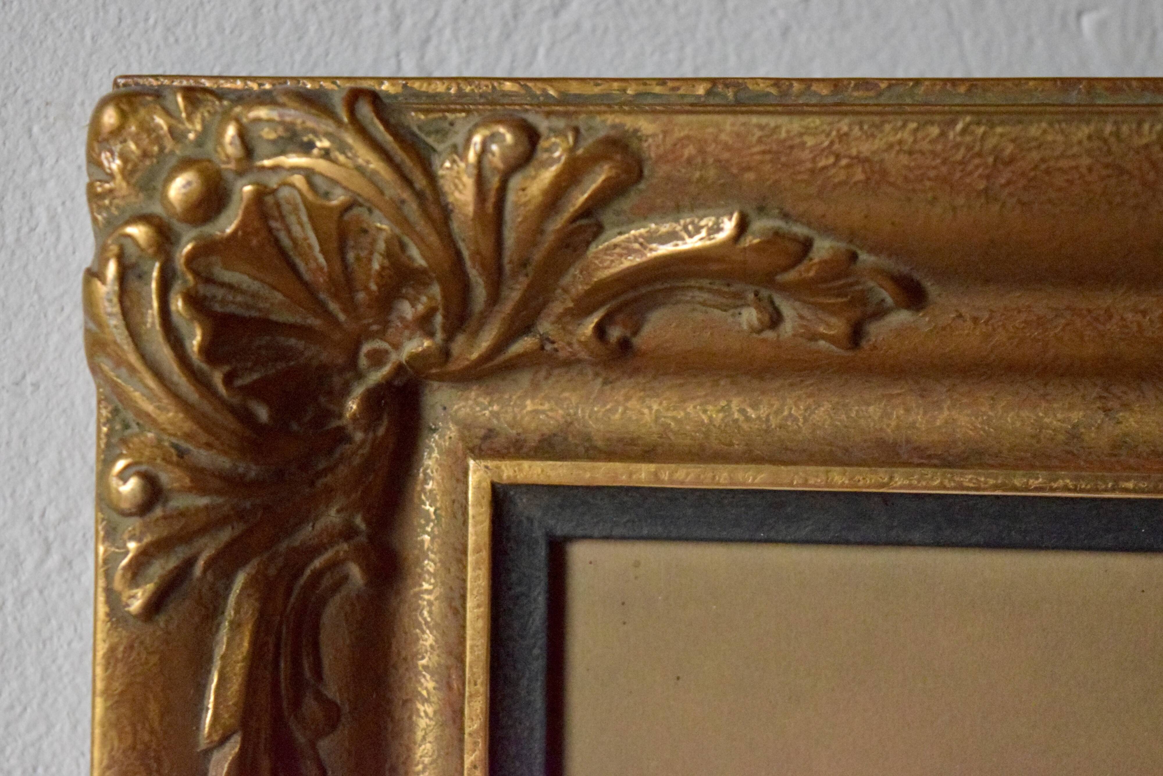 Old large wall frame in gilded carved wood