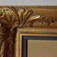 Old large wall frame in gilded carved wood